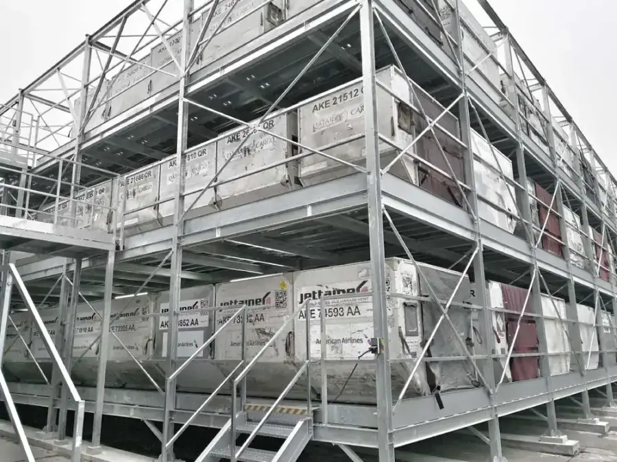 Outdoor three-level galvanized steel rack storing empty AKE containers for WFS at Frankfurt International Airport, Germany